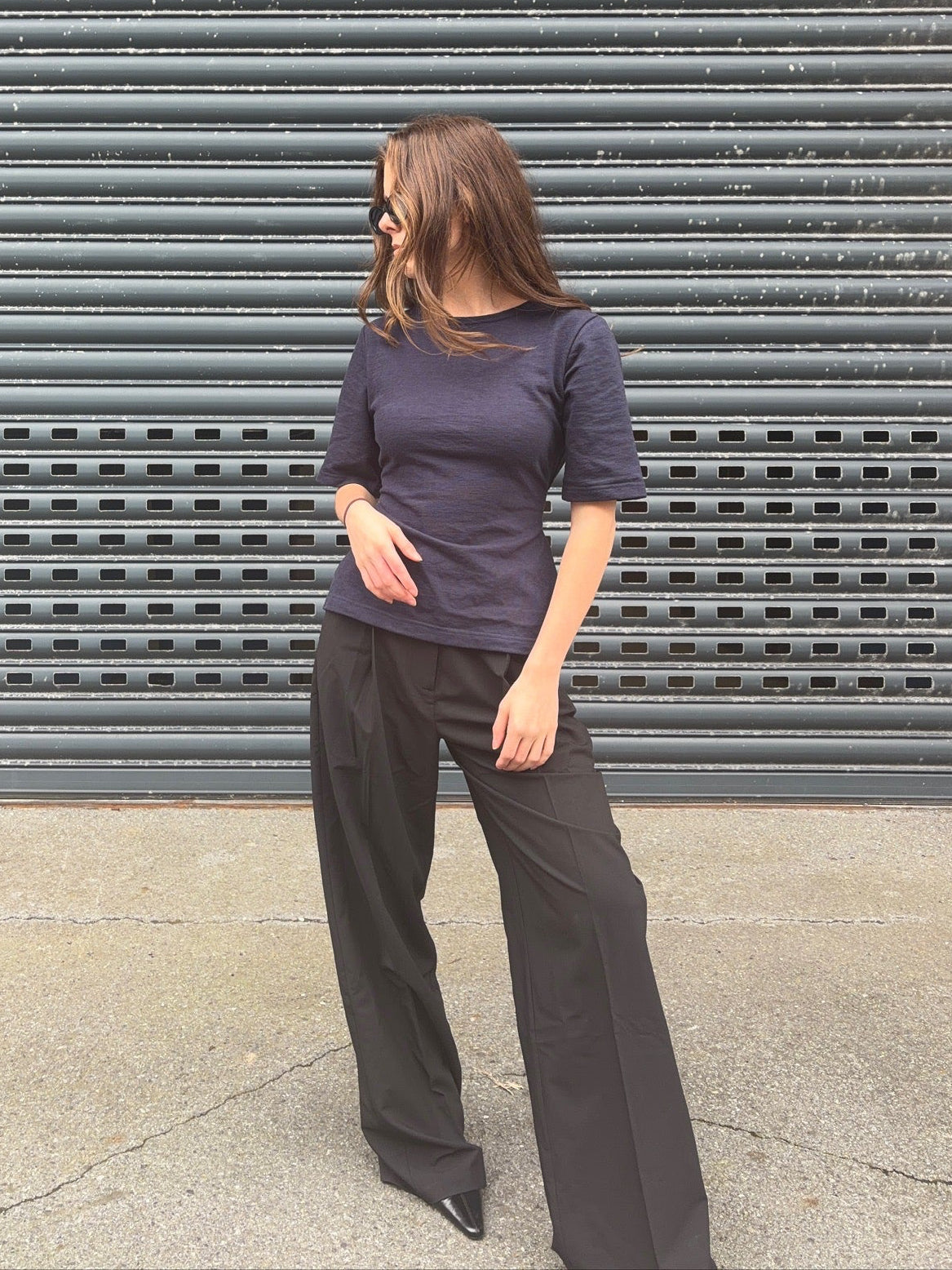A woman wearing the Lou Short Sleeve Navy Top. Straight angle view.