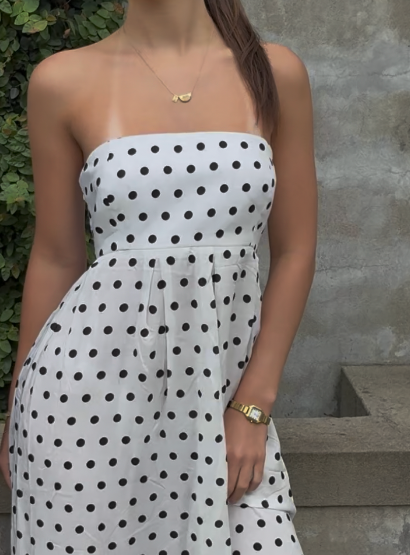 White polka dot strapless maxi dress with fitted bodice and flowy skirt