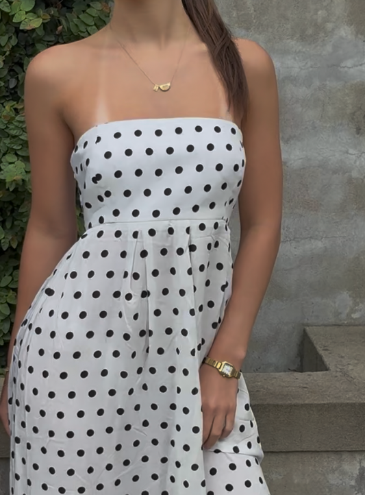 White polka dot strapless maxi dress with fitted bodice and flowy skirt